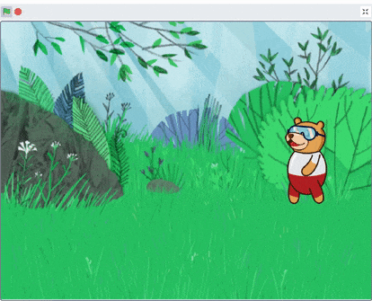 Tobi the bear sprite standing in a forest backdrop in PictoBlox